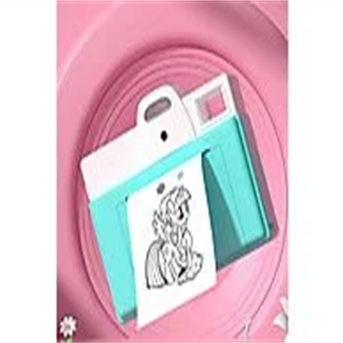 Rosa Spielzeugkamera mit tealfarbenem Oberteil und weißem Griff. Auf dem Papier ist ein Zeichentrickpony abgebildet.