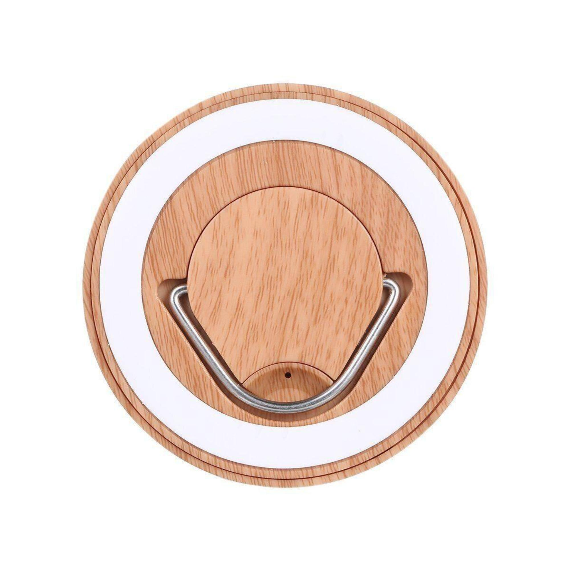 Draufsicht auf ein Holz-strukturiertes Licht mit weißem Ring und Metallgriff.