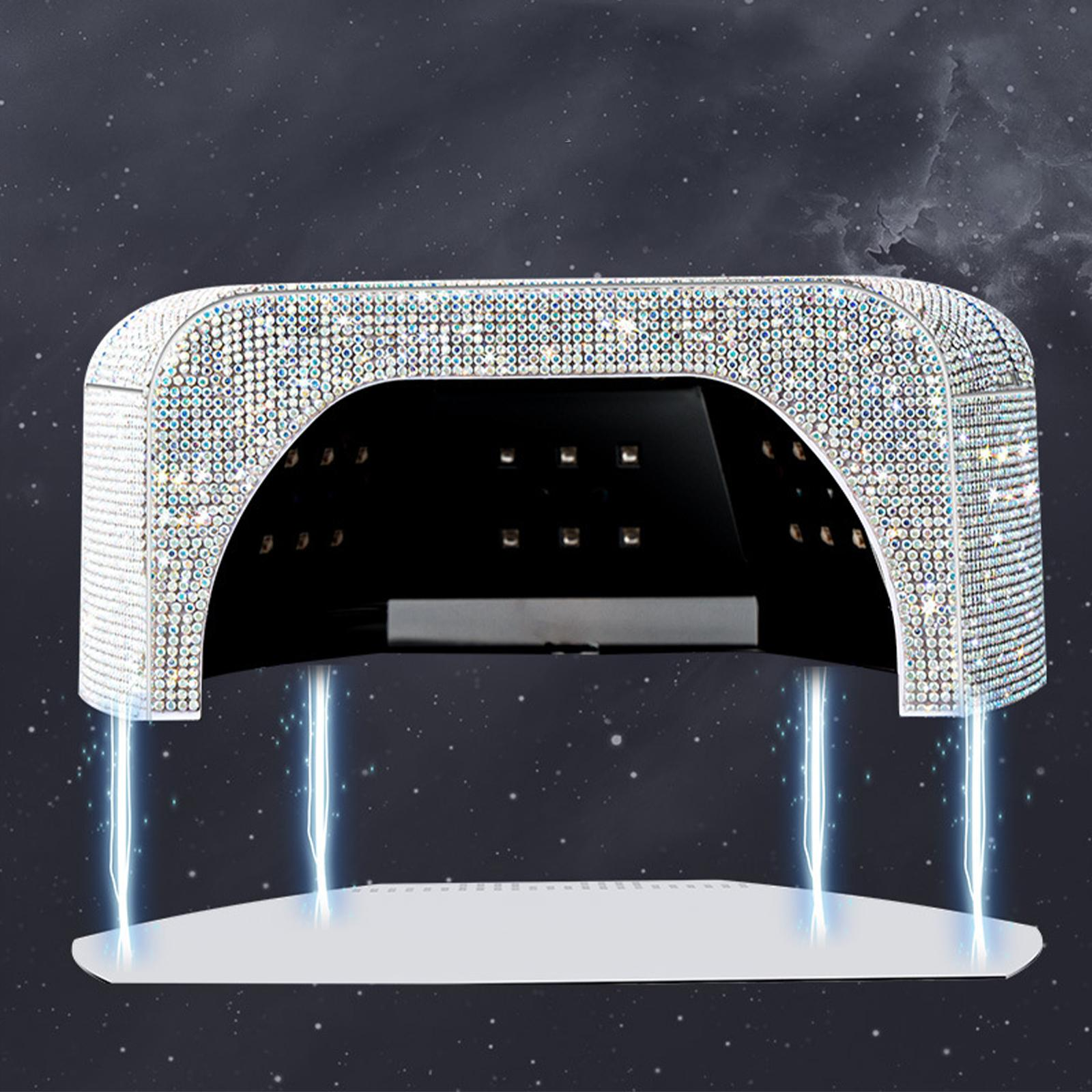 Eine Nagel-Lampe mit Strass, weißer Plattform und blauen Blitzeffekten.
