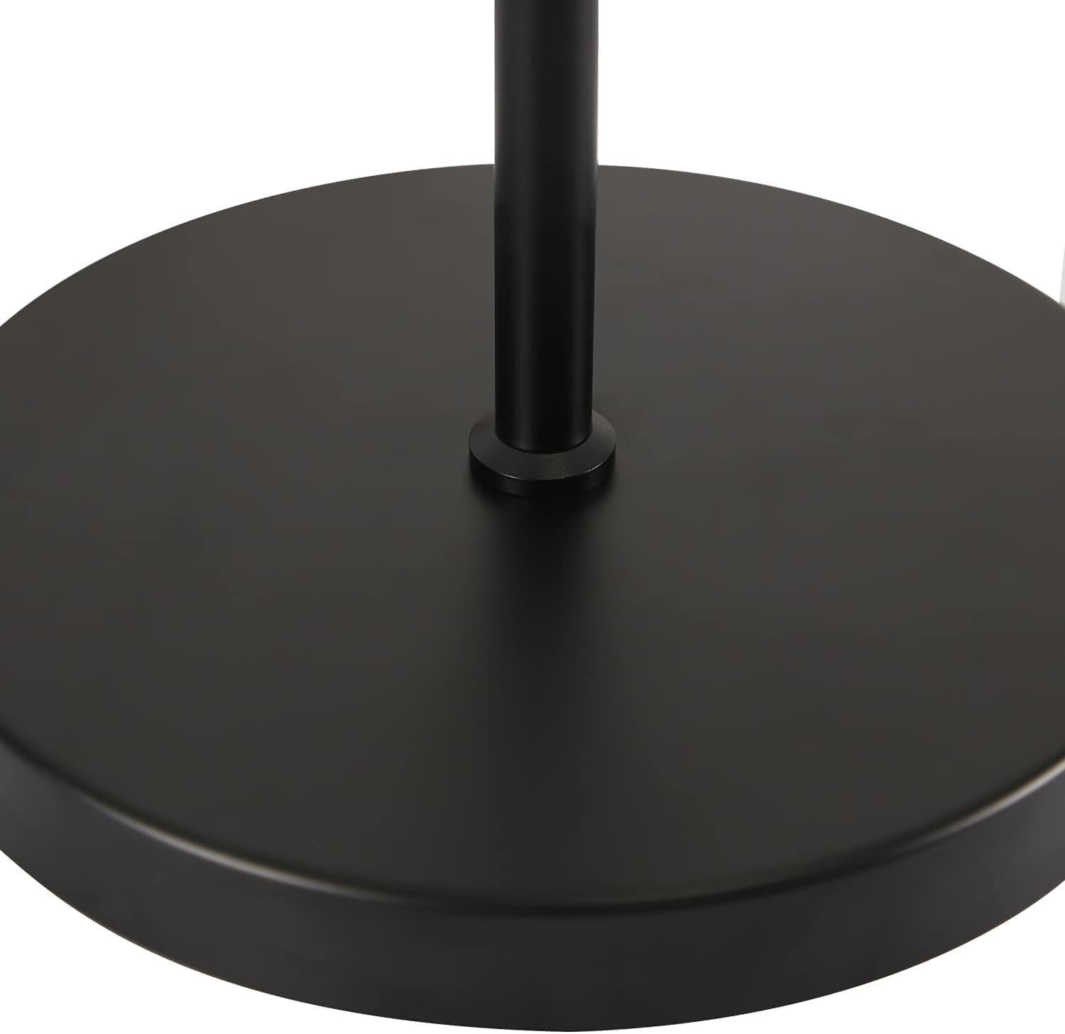 Base nera di una lampada. La base è circolare, con uno stelo nero che esce dal centro.