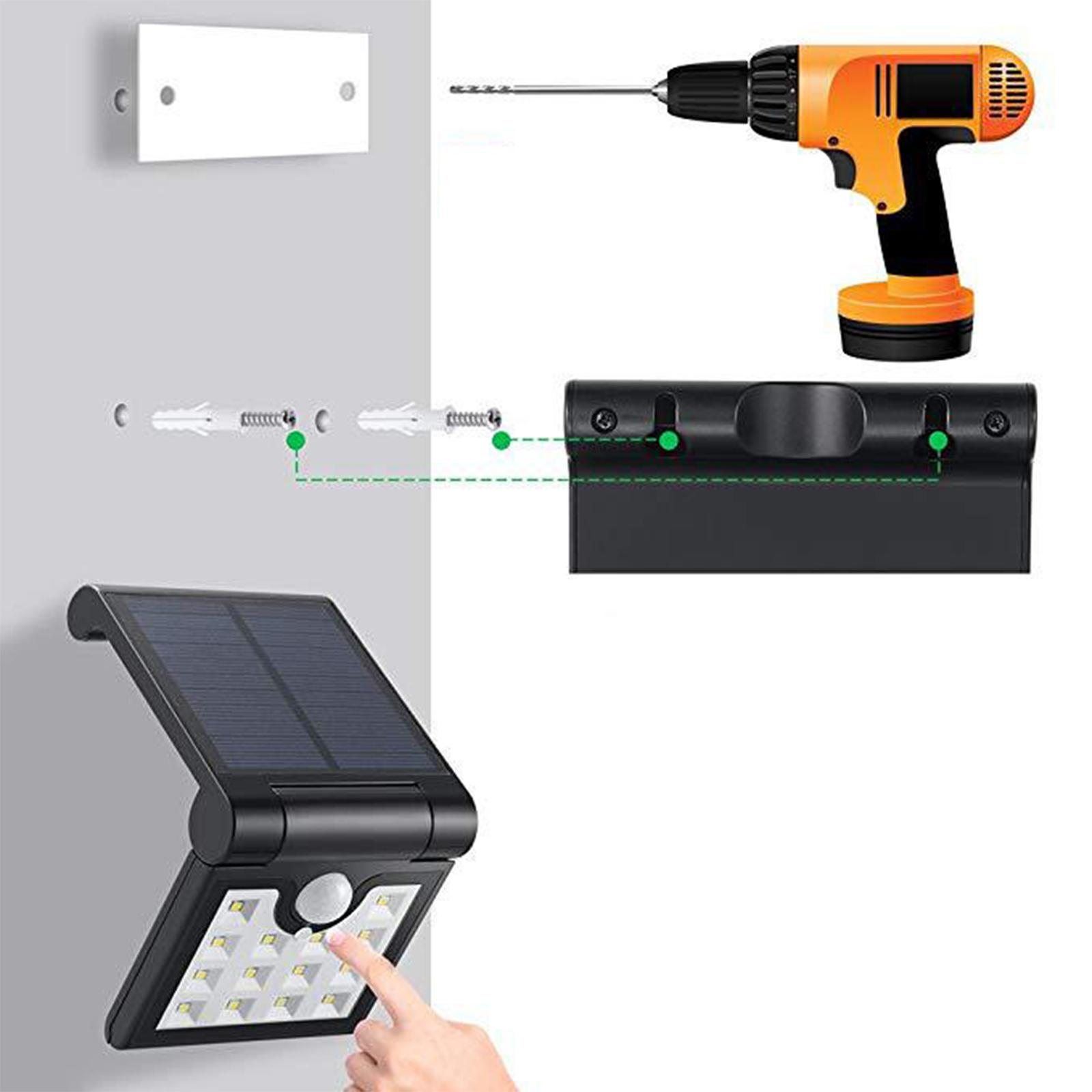 Solarlicht mit Bohrer, Schrauben und weißer Wand installiert. Eine Hand berührt das Licht.