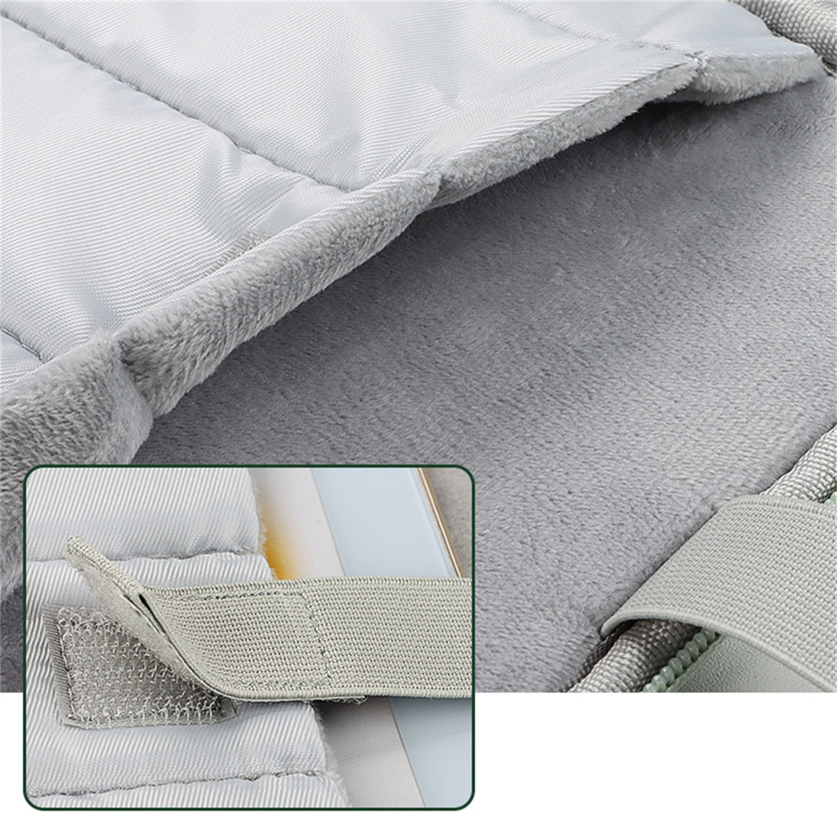 Nahaufnahme von grauem, gepolstertem Material mit Klettverschluss und Stoffstruktur.