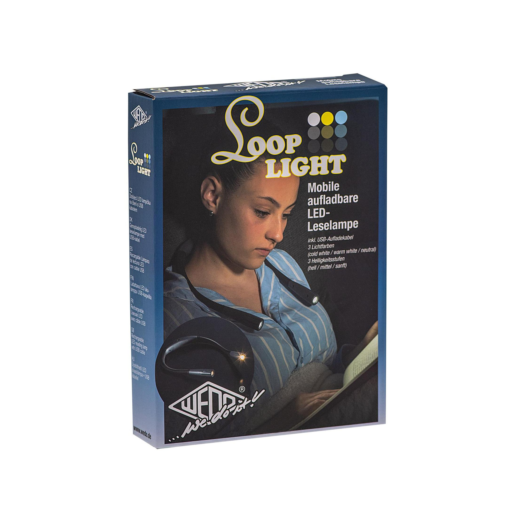 Pudełko z lampą LED 'Loop Light'. Kobieta czyta książkę. Lampa jest na książce.