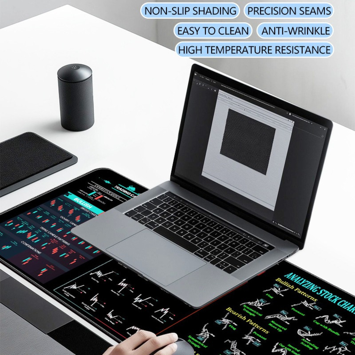 Laptop, mouse and chart pattern mouse pad on a white desk. Text about the pad is visible.