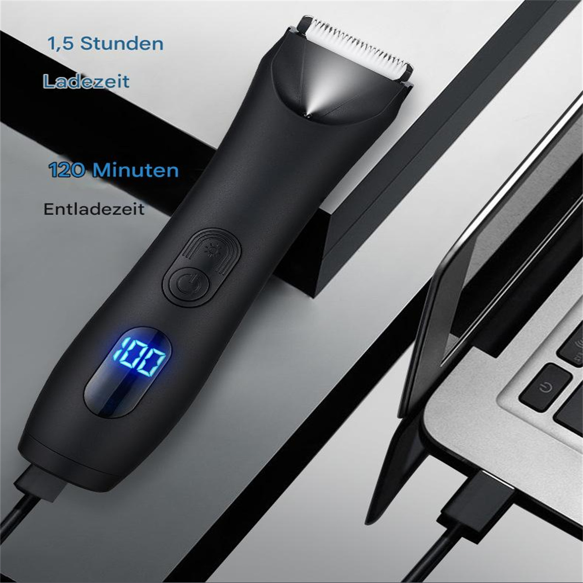 Schwarzer Trimmer mit Digitalanzeige und Laptop im Hintergrund.