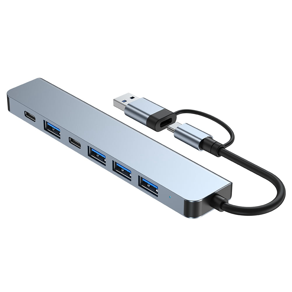 Ein silberner USB-Hub mit mehreren Anschlüssen und einem USB-C-Kabel.