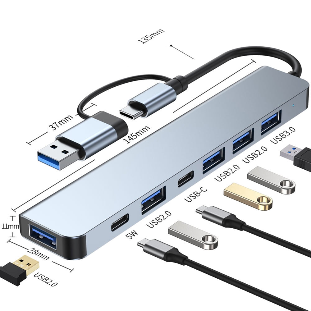 Ein silberner USB-Hub mit mehreren Anschlüssen und einem USB-Kabel. Abmessungen und Anschlüsse sind beschriftet.