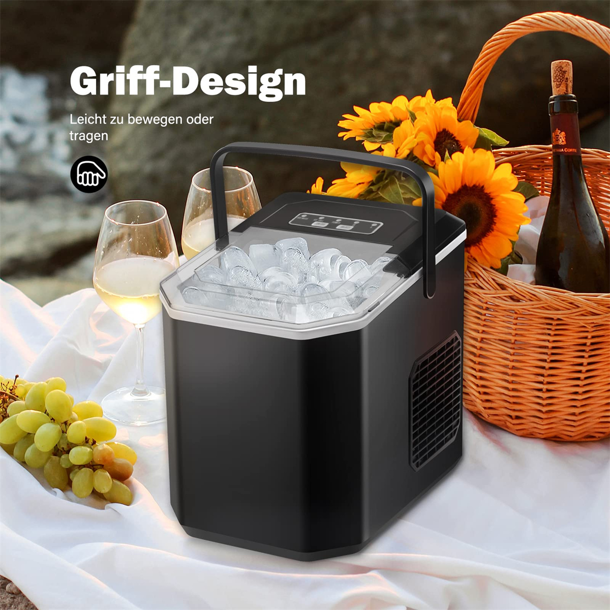 Schwarzer Eisbereiter mit Eis, zwei Weingläser, Trauben, Sonnenblumen und Picknickkorb.
