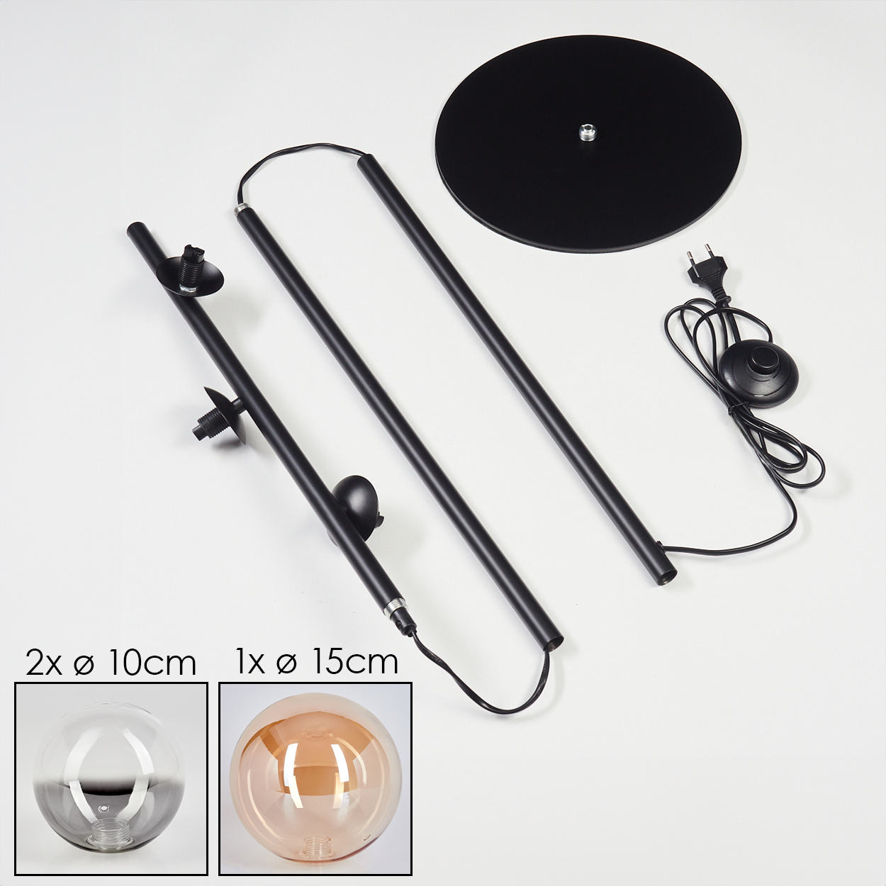 Eine zerlegte Lampe mit Teilen: Sockel, Stäbe und Glasschirme. Zwei sind klar, einer bernsteinfarben.