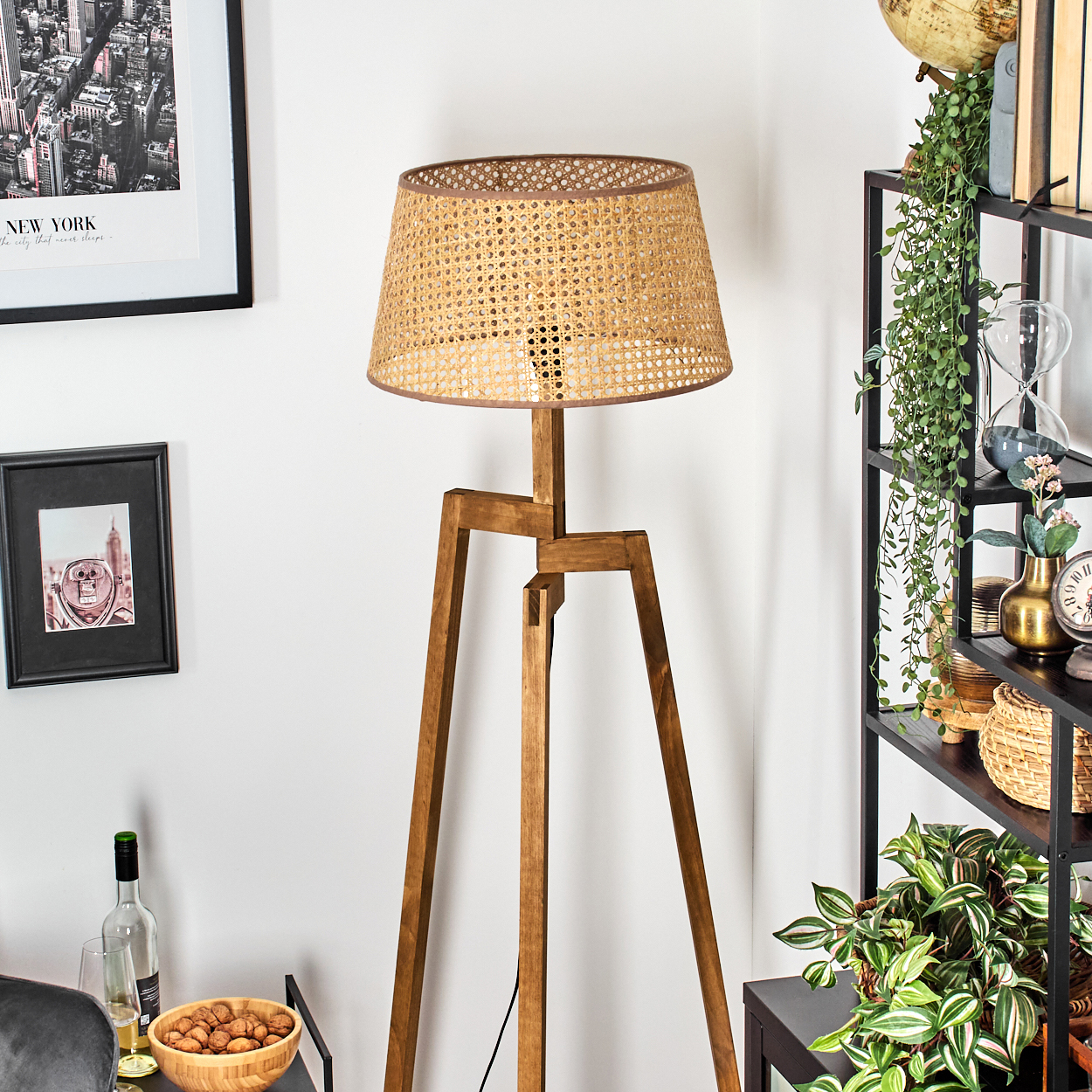 Holz-Stativ-Stehlampe mit gewebtem Schirm. Innenszene mit Dekor. Weiße Wand und Ecke.