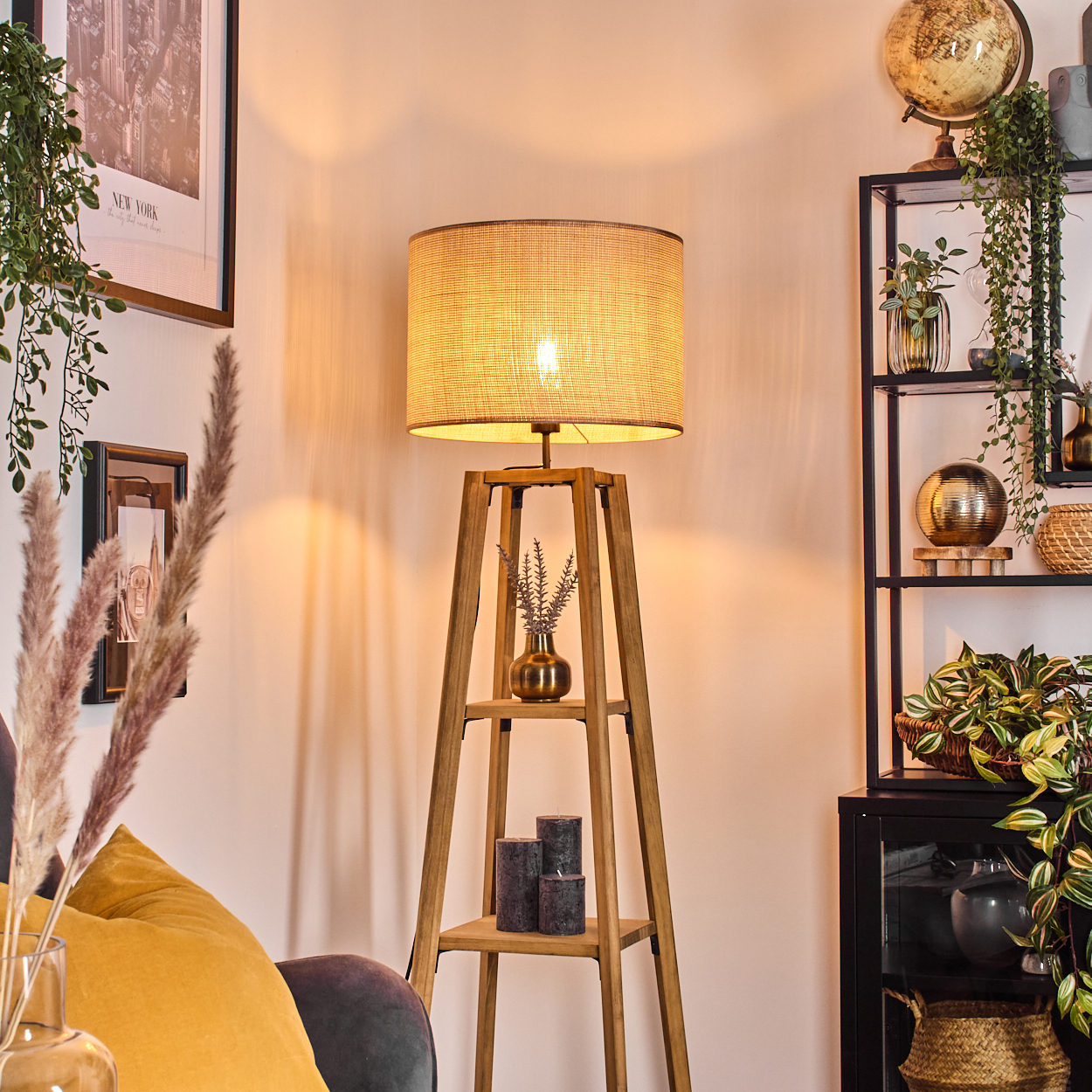Eine beleuchtete Stehlampe aus Holz mit Lampenschirm, in einem Raum mit Dekoration.