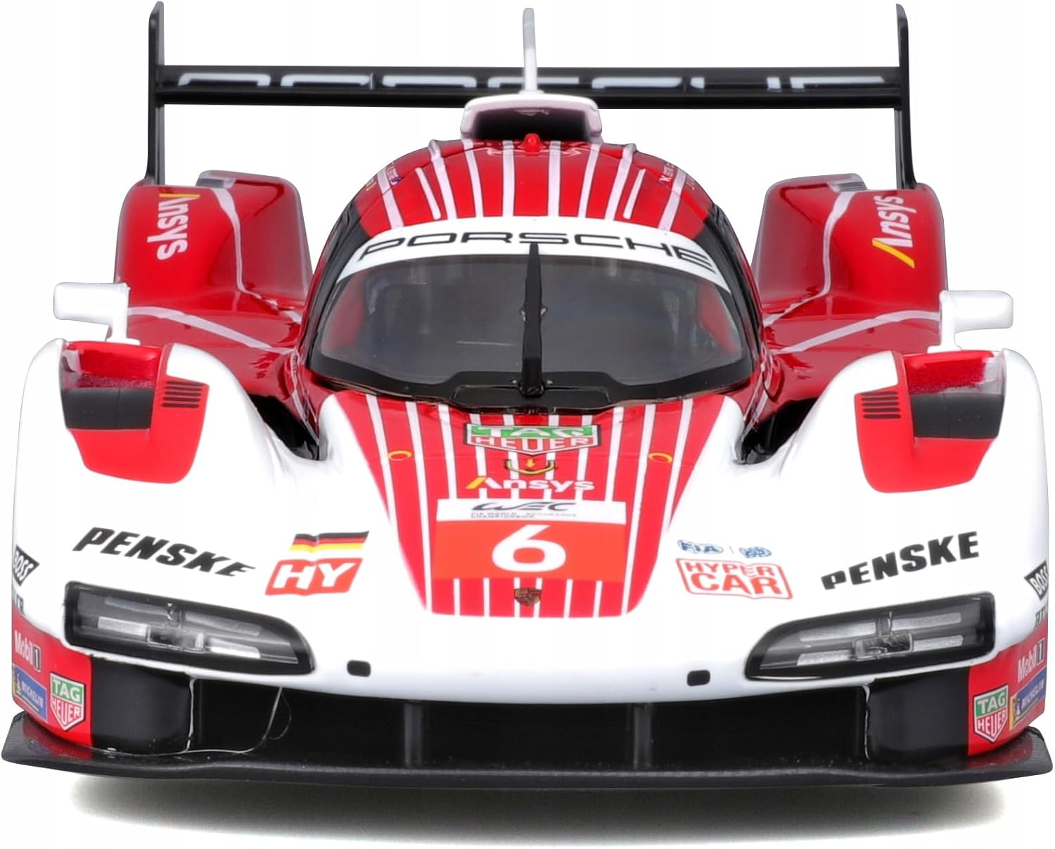 Ein rotes und weißes Porsche-Rennwagen-Spielzeug mit der Nummer 6 in einer Box.
