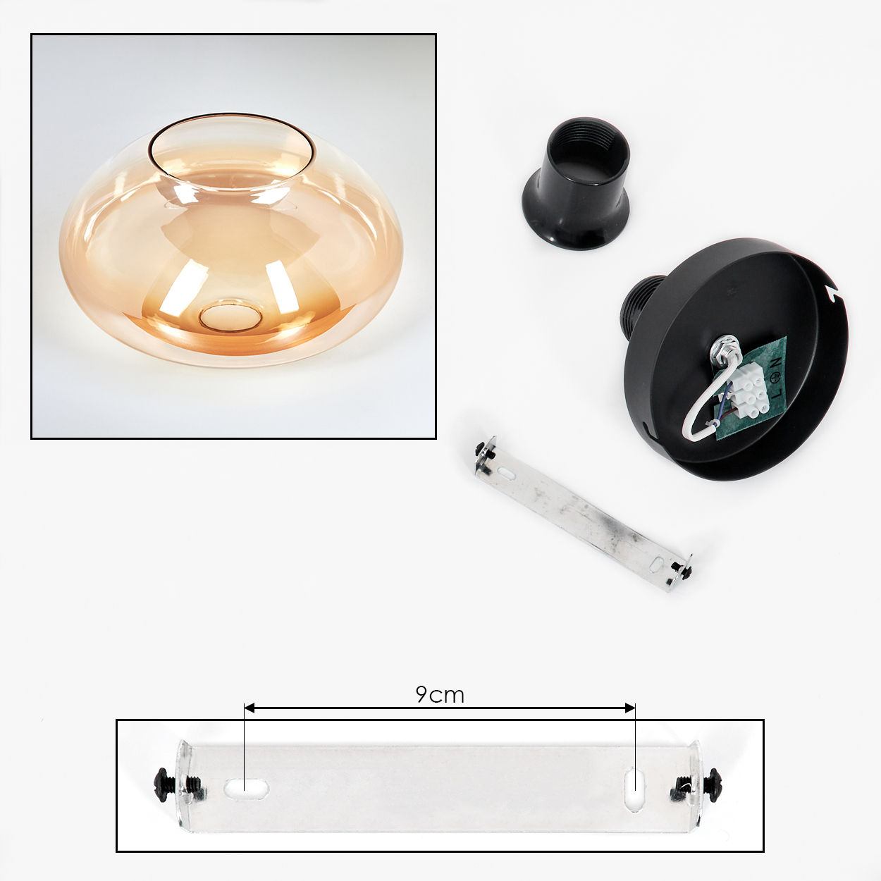 Glaslampenteile zerlegt. Bernsteinfarbener Glasschirn und schwarze Armaturen. Weißer Hintergrund.
