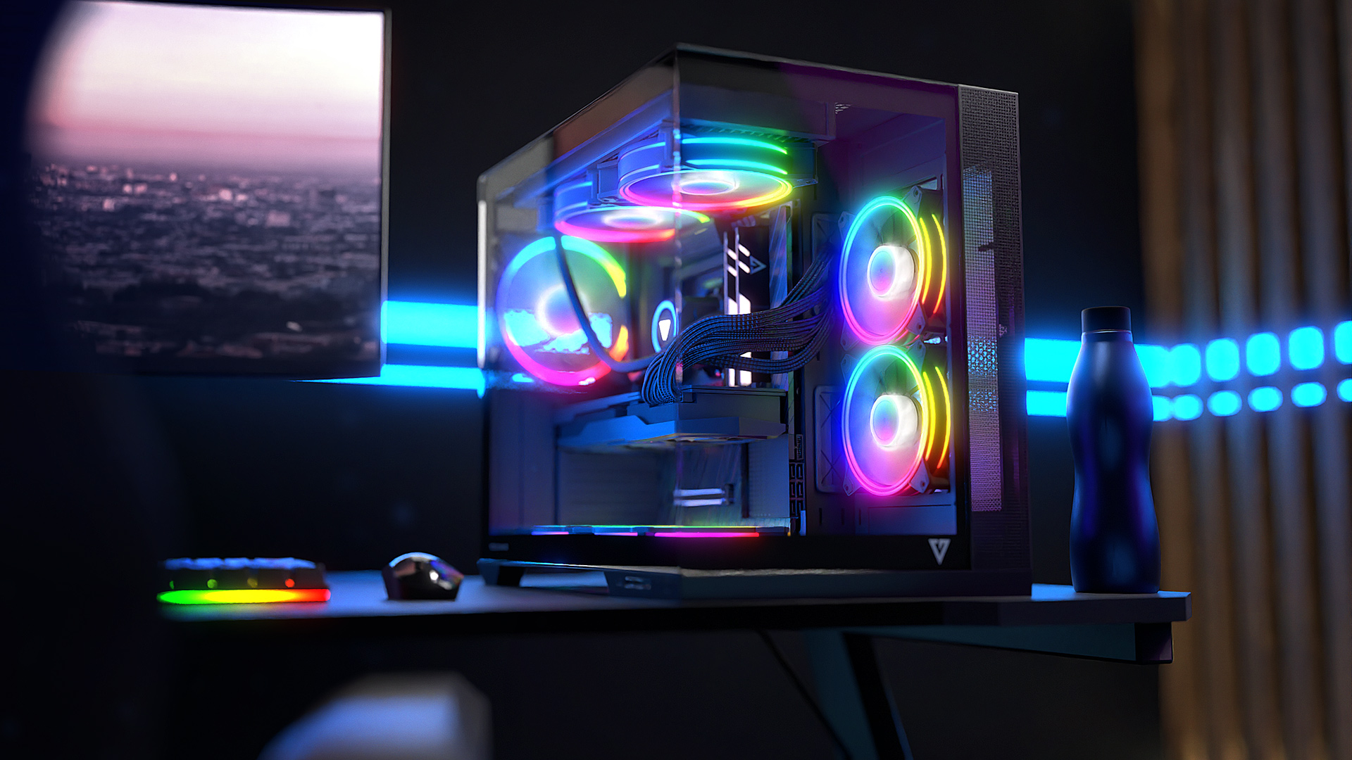 Konfiguracja komputera na biurku. Czarna obudowa z wentylatorami RGB, monitorem, myszą i butelką wody po prawej.