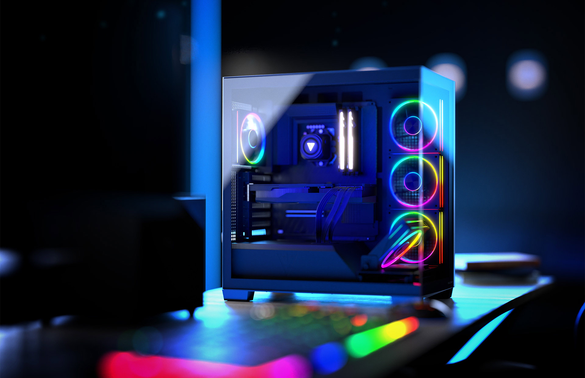 Obudowa komputera z oświetleniem RGB, komponentami wewnętrznymi i ustawieniem biurka z klawiaturą.