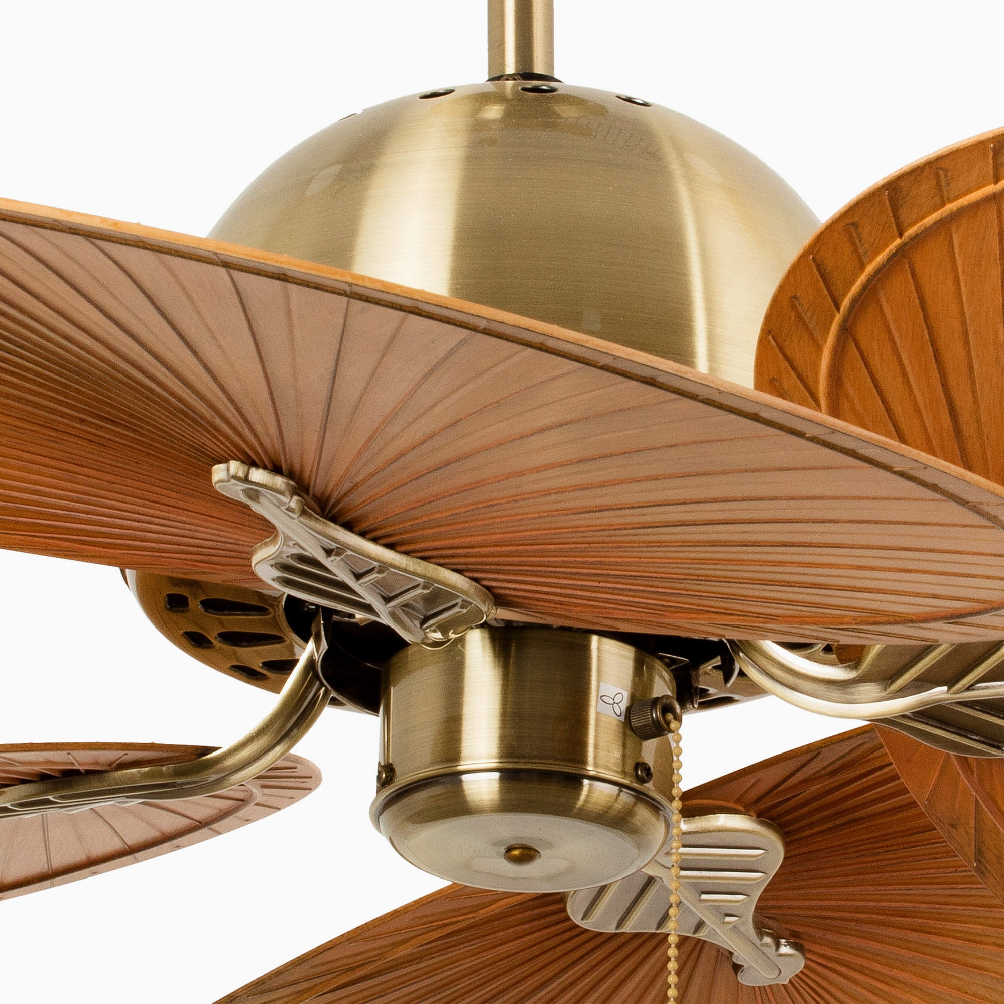 Primo piano di un motore di ventilatore da soffitto in ottone con pale in finitura legno, con catena e altri dettagli.