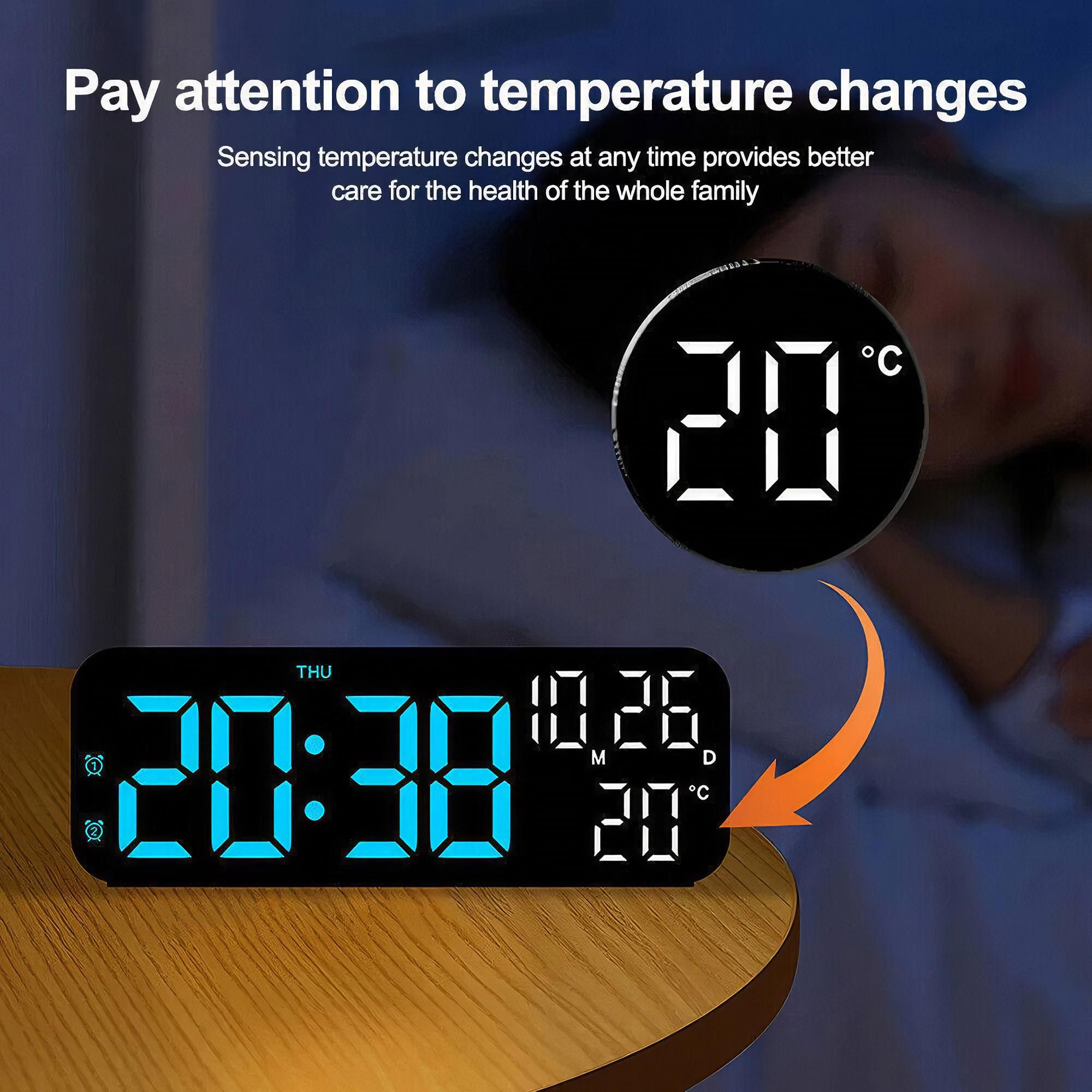 Digitaluhr mit Anzeige von Zeit und Datum. Eine kleinere runde Uhr mit Temperaturanzeige. Nachtszene.