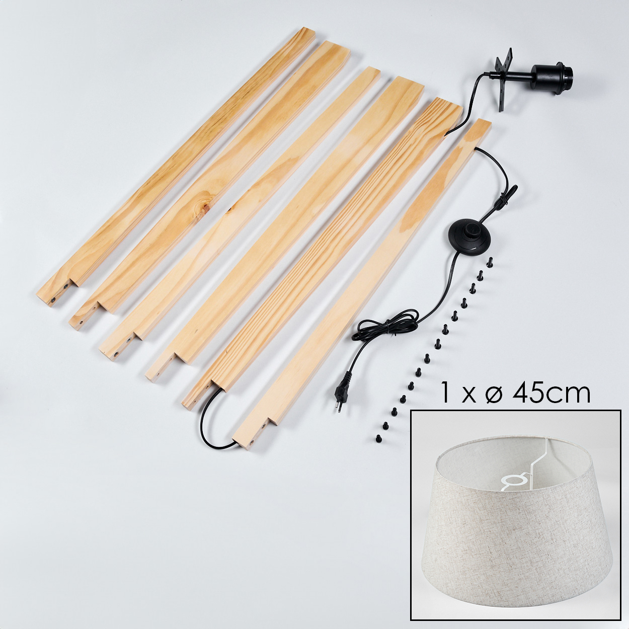 Ein Lampen-Kit wird mit Holzteilen, einer Leuchte und einem Lampenschirm gezeigt. Der Hintergrund ist weiß.