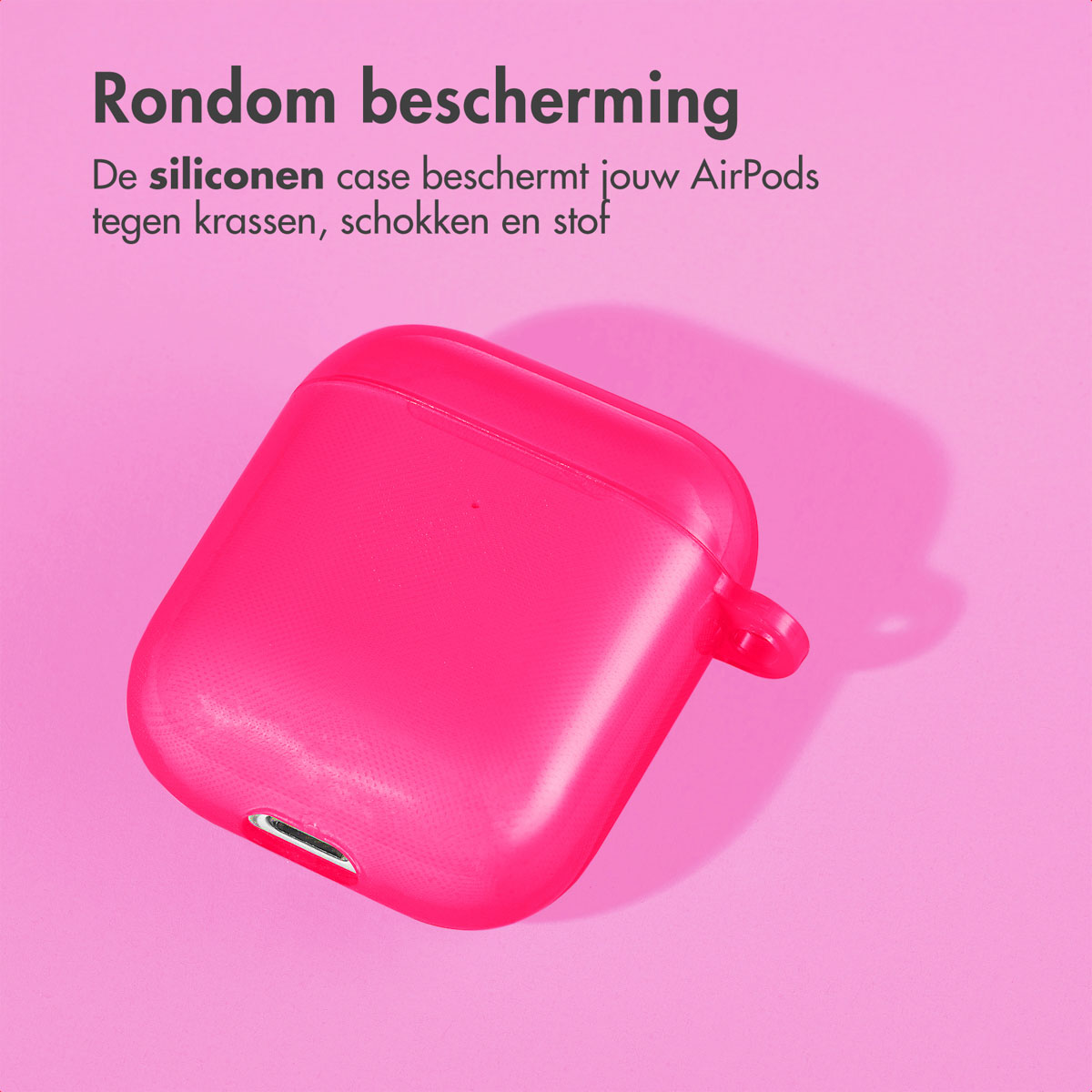 Pink AirPods case on pink surface. It has a smooth surface.
