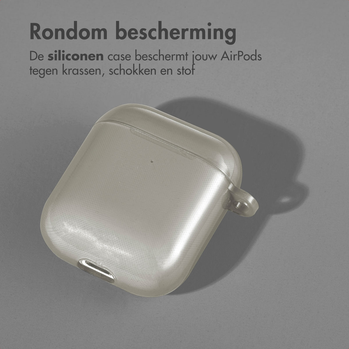 Gray AirPods case on a surface with a shadow. Text is present above the case.