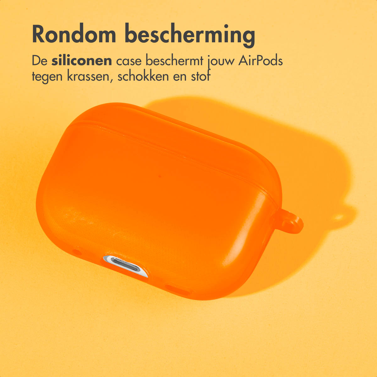 Orange AirPods case on a surface with a shadow. Text is present above the case.