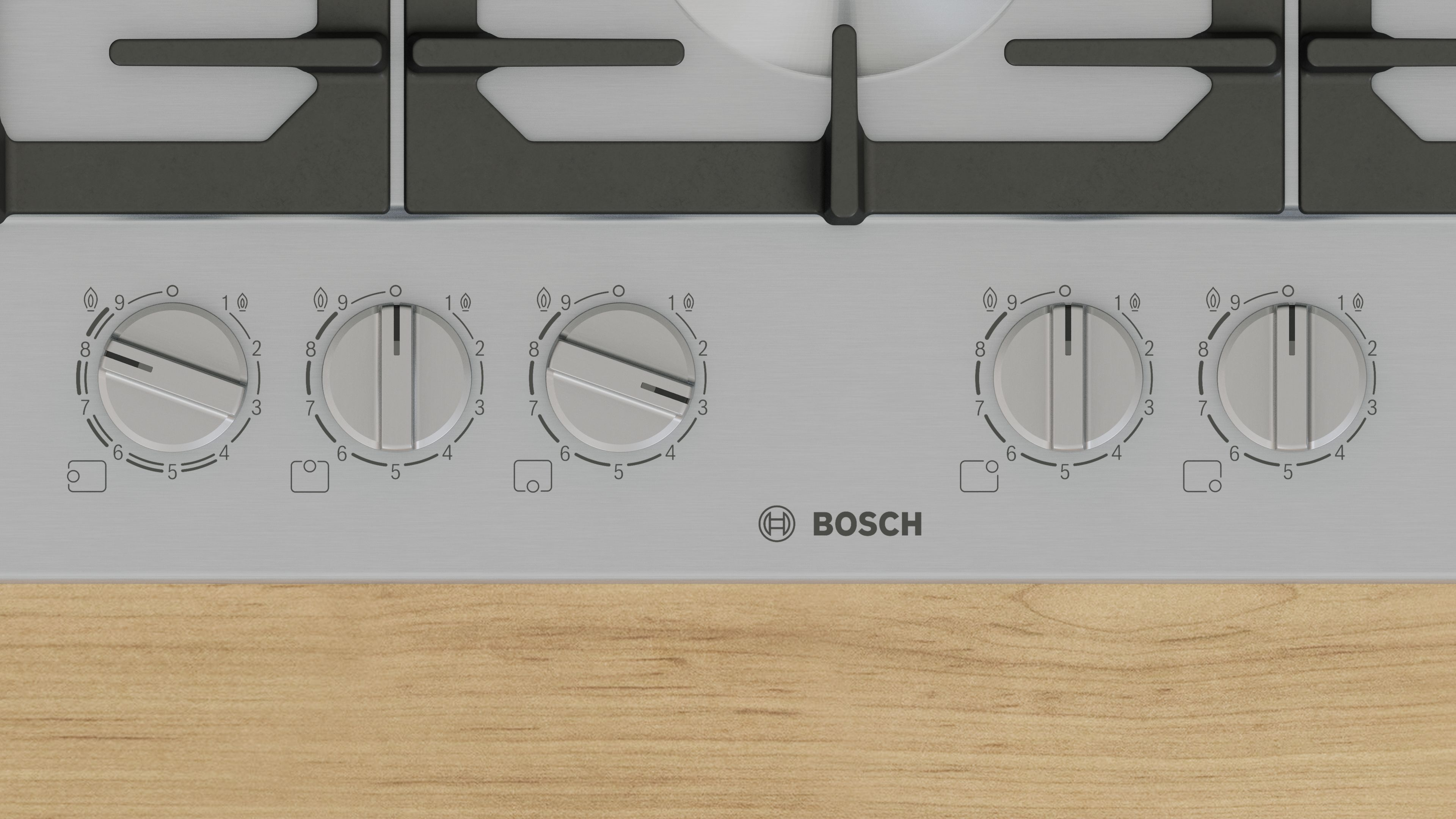 Primo piano delle manopole di controllo di un fornello a gas con numeri e logo Bosch.