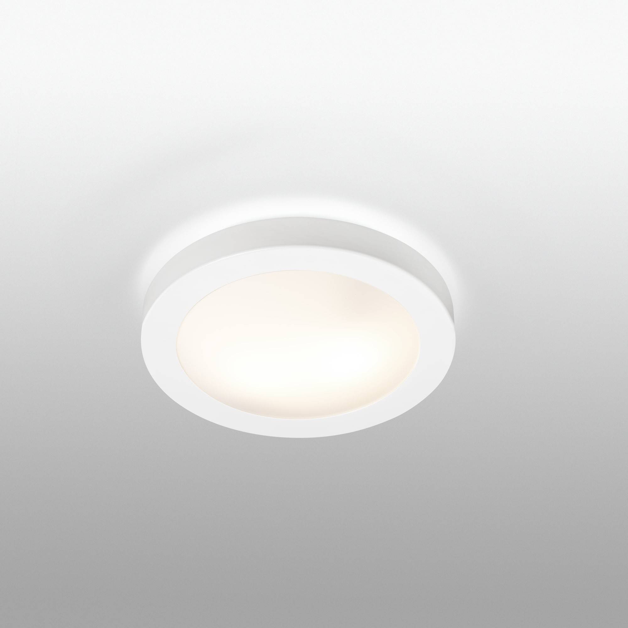 Una luce da soffitto circolare bianca con un centro luminoso, su sfondo bianco.