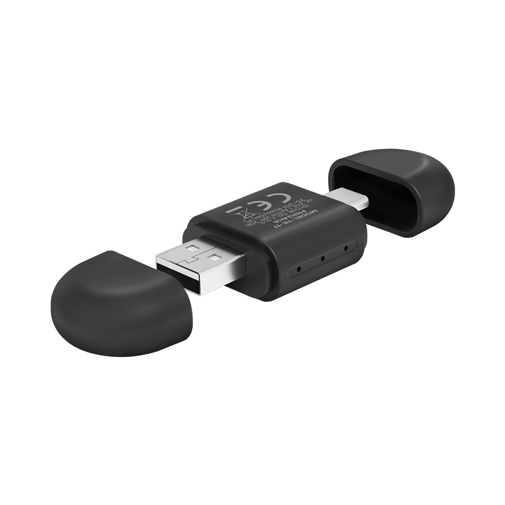 Un adaptador USB negro con dos tapas redondeadas, una abierta.
