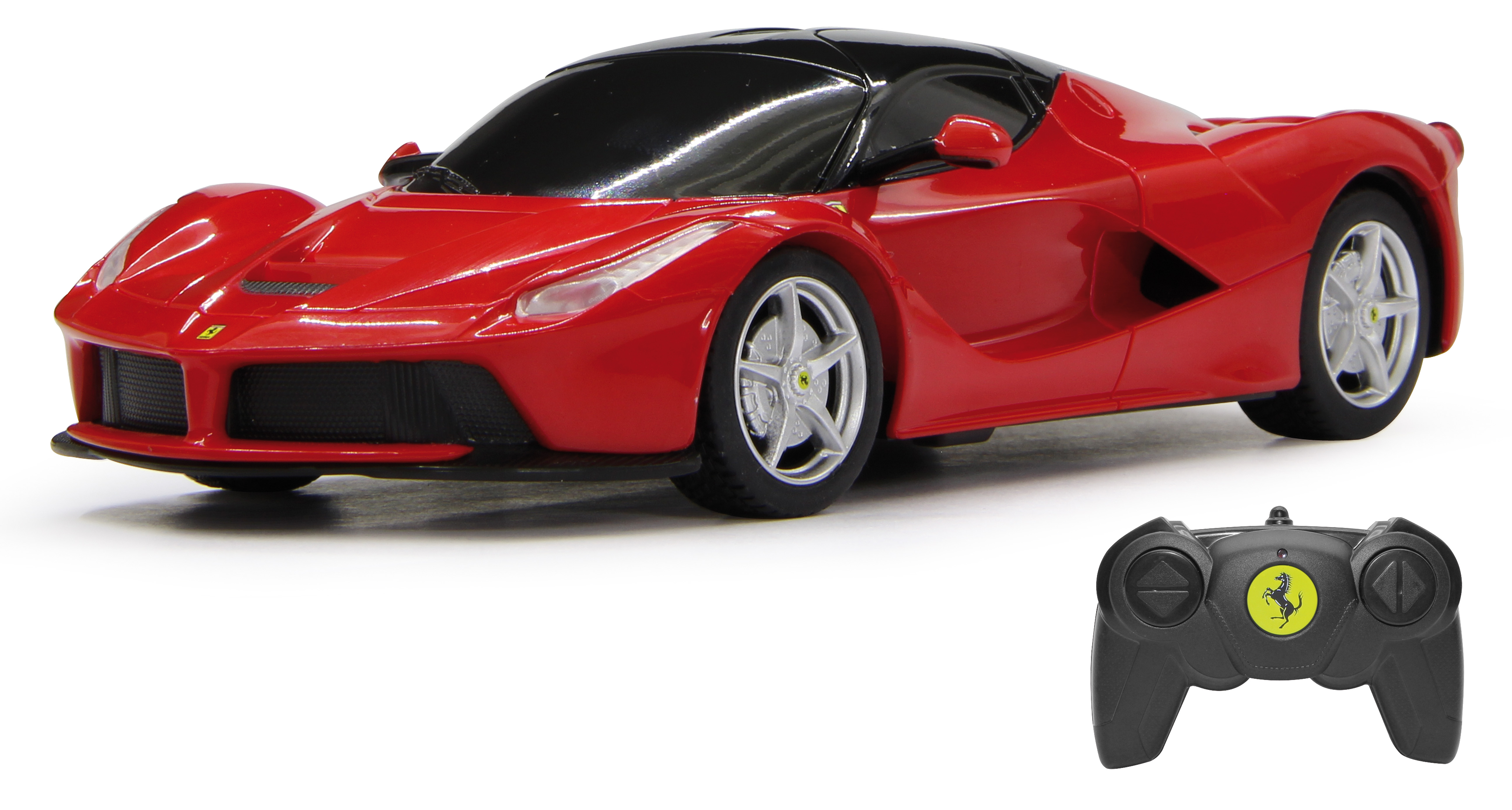 Czerwony samochodzik i czarny pilot, z logo Ferrari na pilocie.