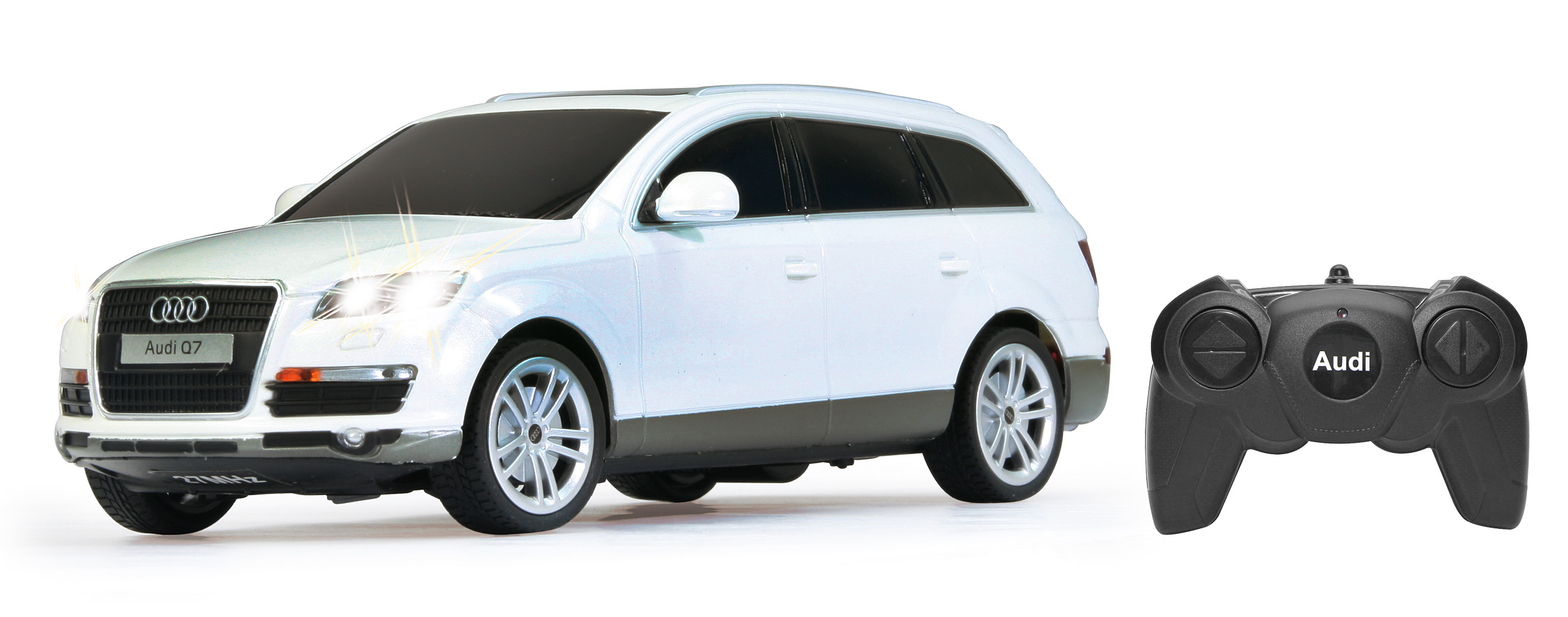 Biały samochodzik Audi Q7 z pilotem. Reflektory są włączone.