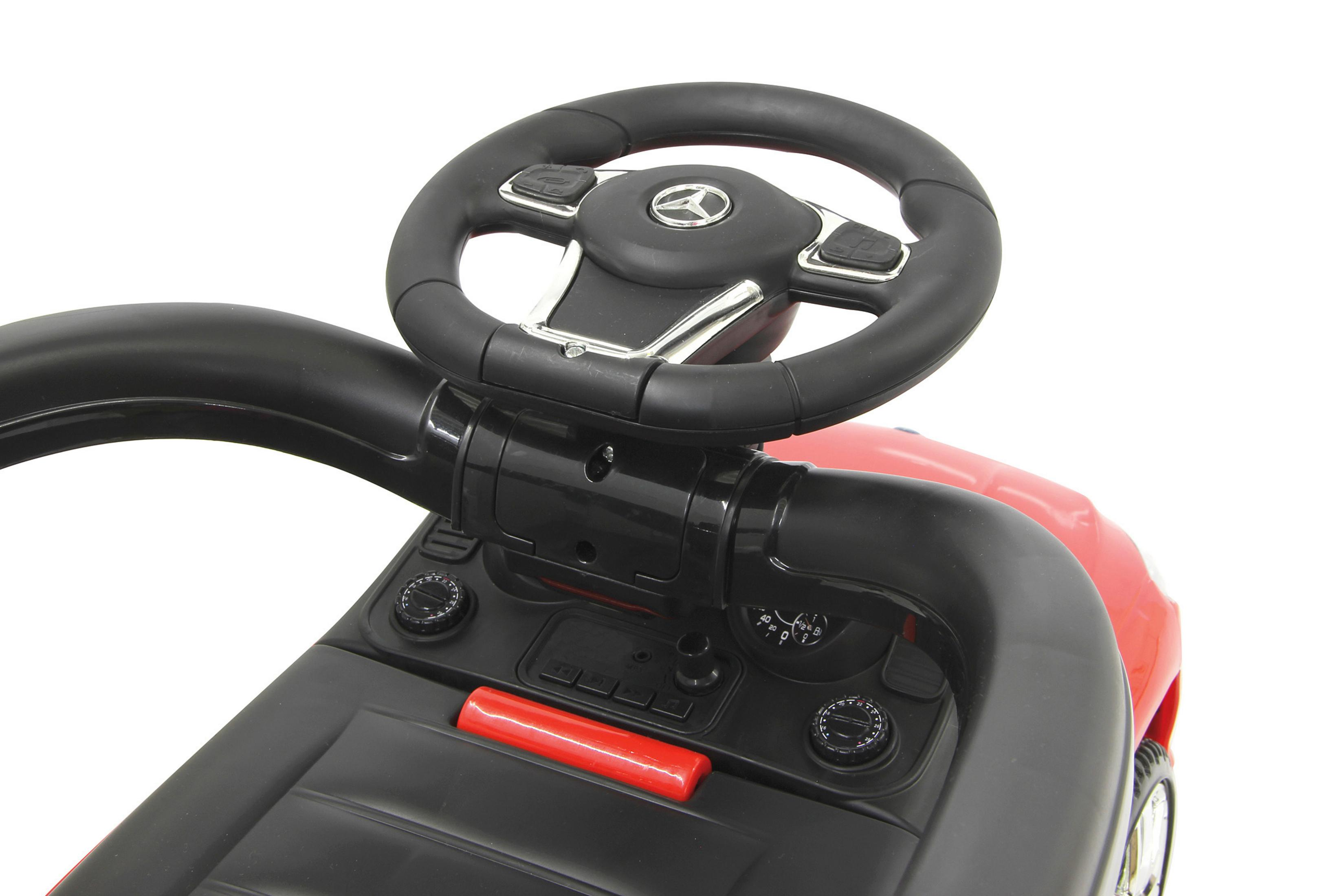 Un coche de juguete rojo con volante negro y asa negra.