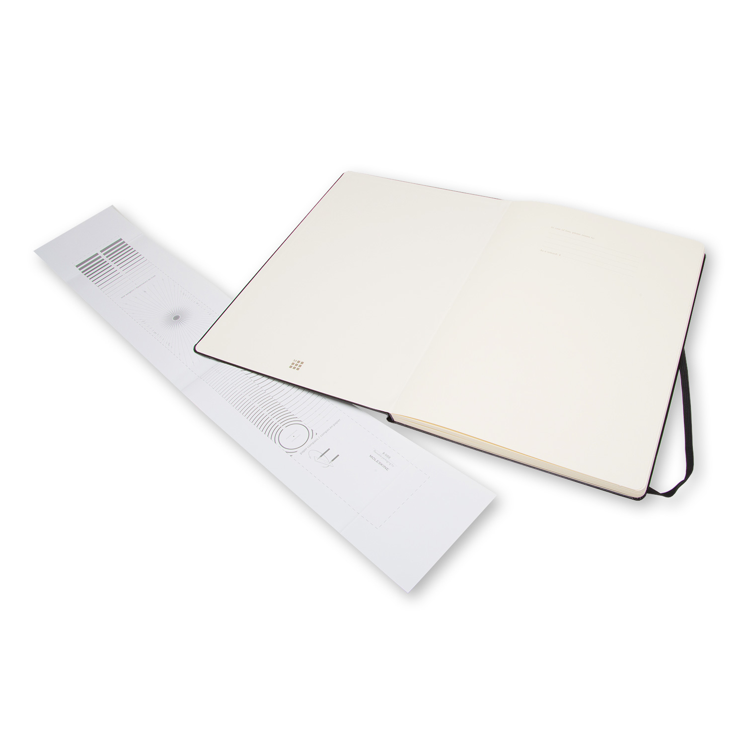 Otwarty notatnik z długopisem i kartką z okręgami i liniami na białej powierzchni.