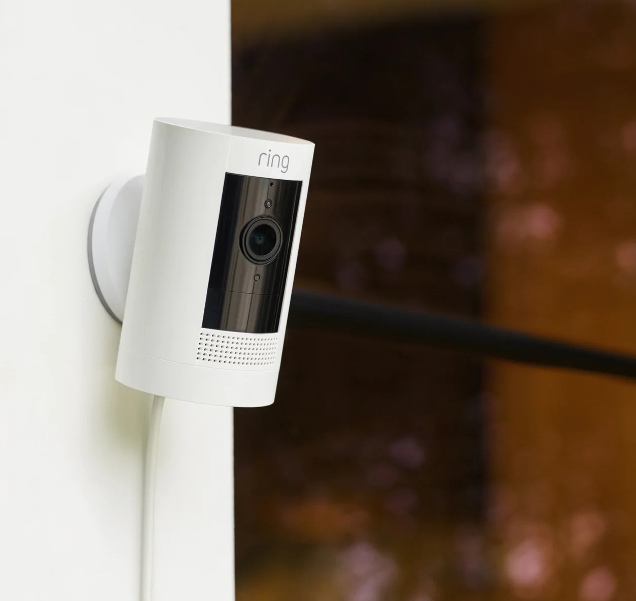 White security camera mounted on a wall.