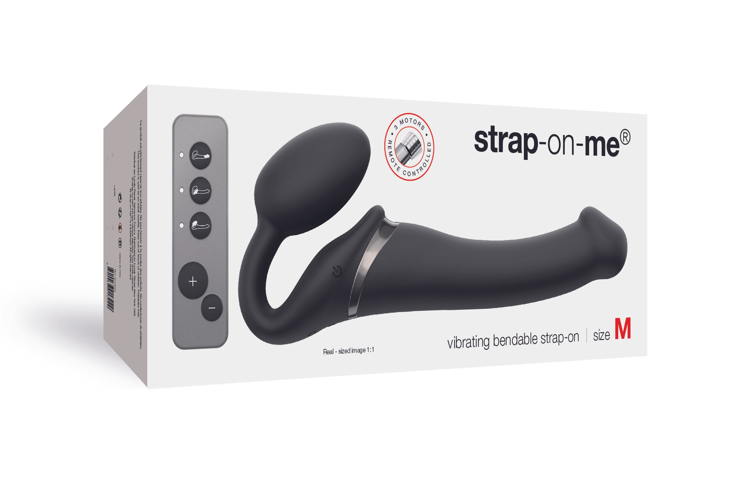 Pudełko z czarną zabawką erotyczną i pilotem. Tekst: 'strap-on-me' i 'rozmiar M'.