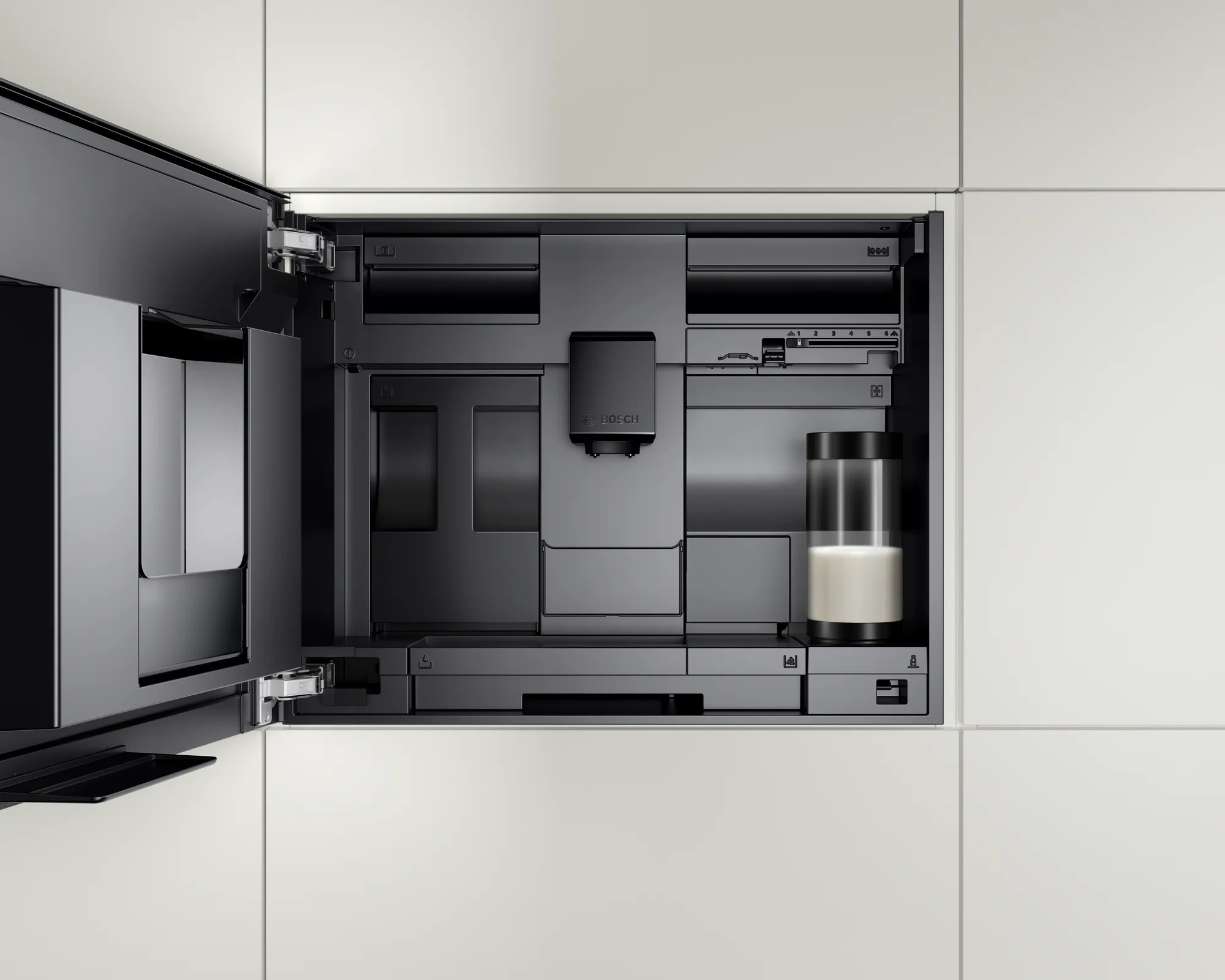 Otwarty wbudowany ekspres do kawy w kuchni. Pokazuje pojemnik na mleko i komponenty.