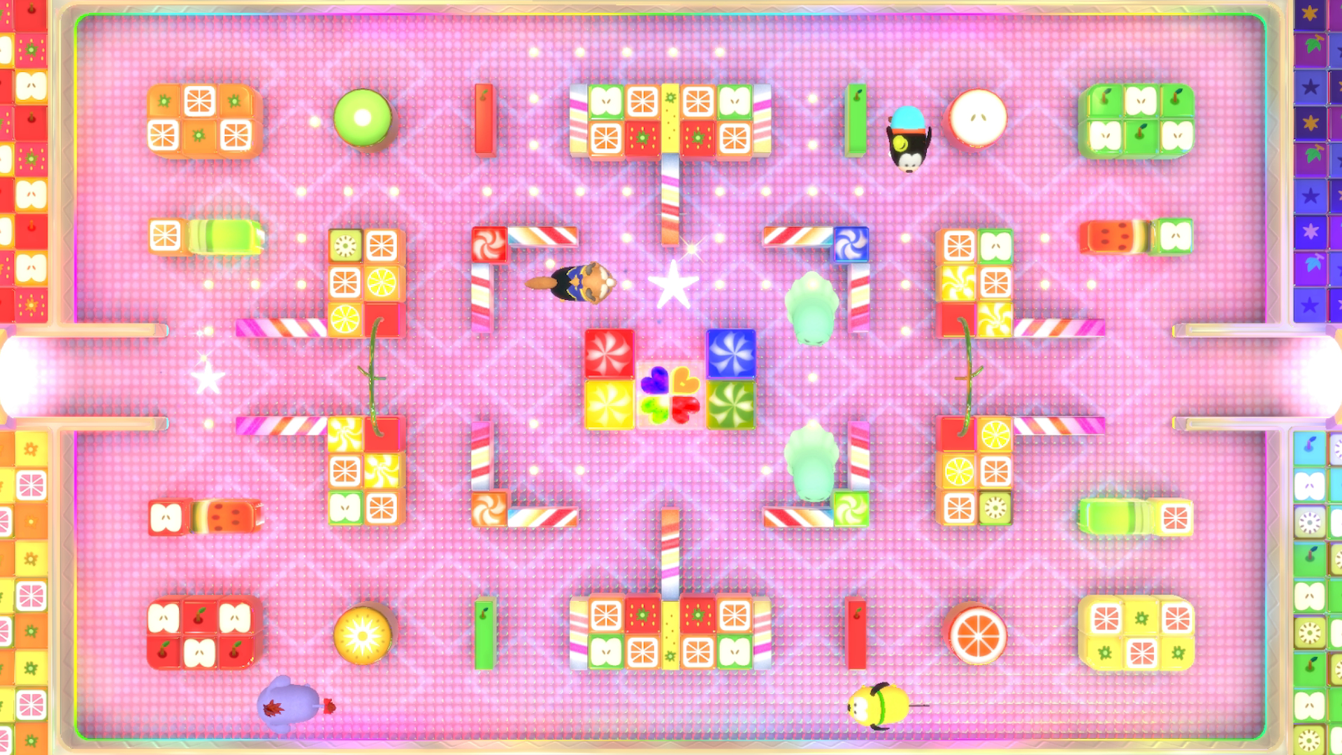 Widok z góry na kolorowy labirynt z różnymi przeszkodami i dekoracjami o tematyce jedzenia.