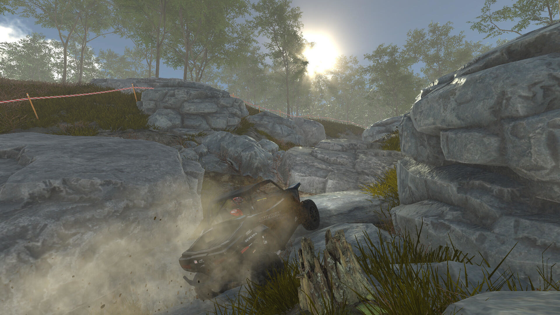 Samochód jadący przez skały i ziemię, ze słonecznym tłem.