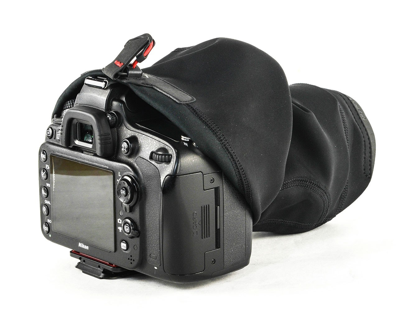 A black camera with a lens cover is on a white background, showing the screen.