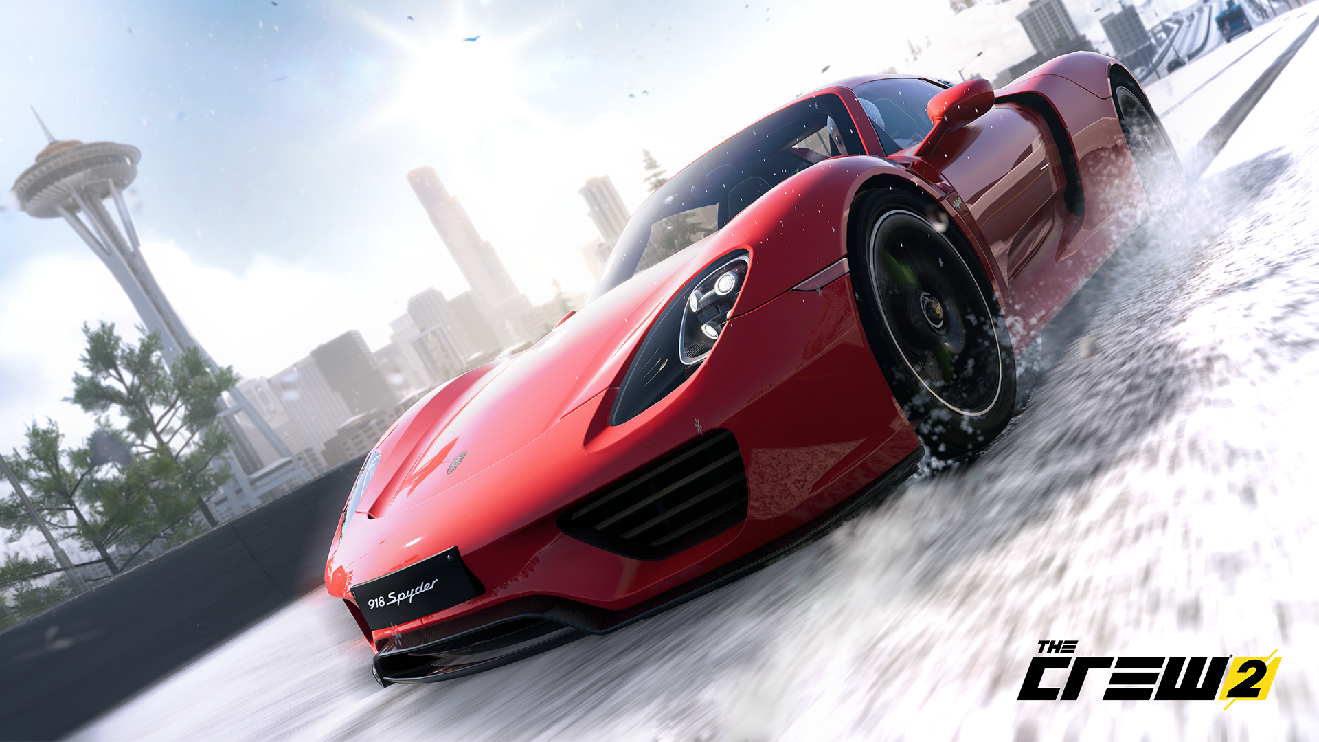 Scena z The Crew 2. Czerwony samochód sportowy driftuje na zaśnieżonej drodze.