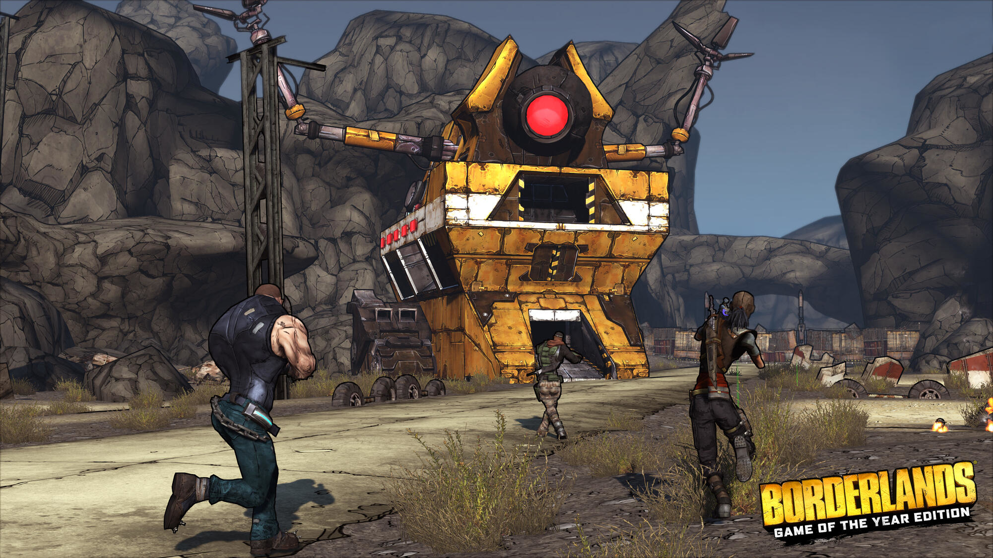 I personaggi corrono verso una struttura. Un grosso robot sullo sfondo. Gioco Borderlands.
