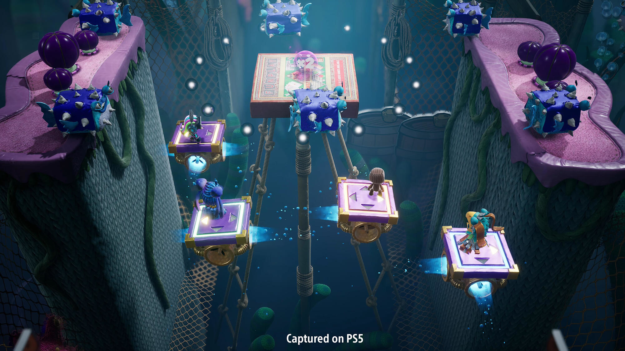 Scena z gry z postaciami platformowymi na pływających platformach w kolorowym środowisku podwodnym.