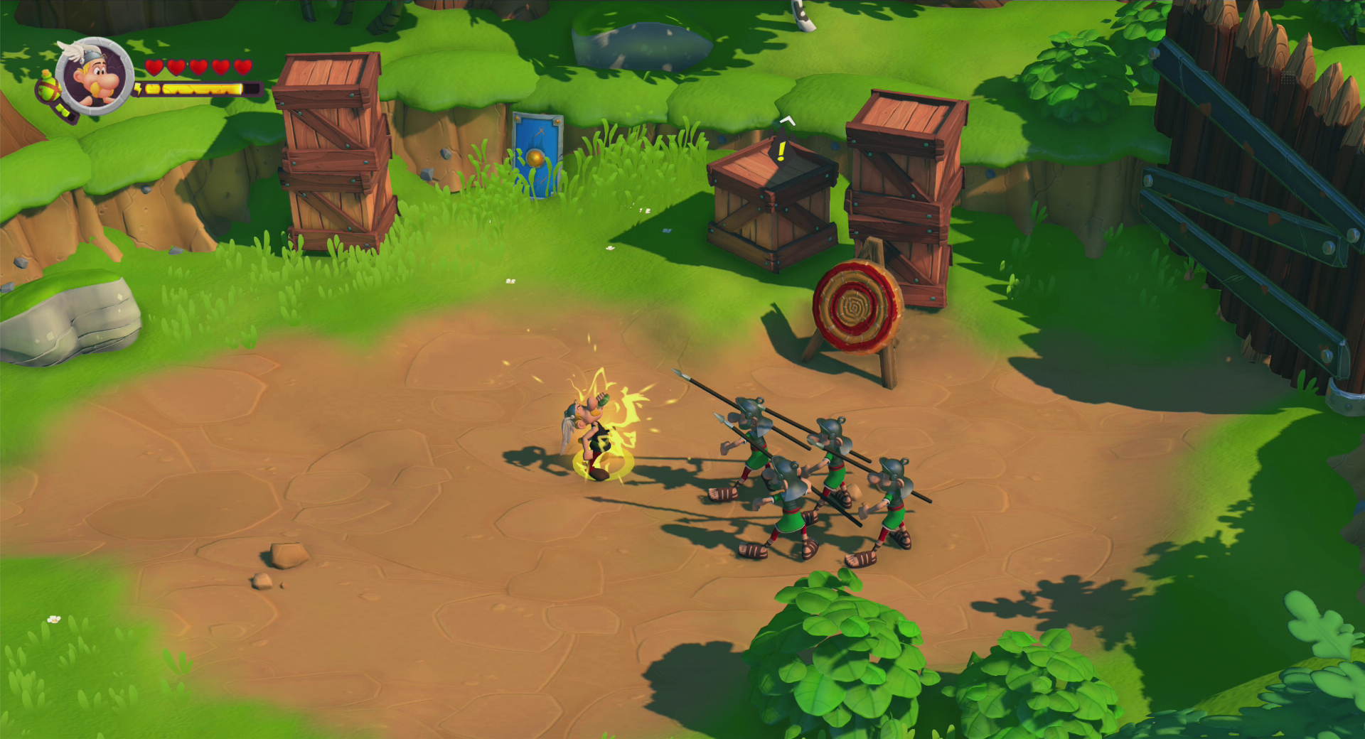 Scena del gioco Asterix. Personaggi che combattono contro i nemici. Un bersaglio e una staccionata di legno sullo sfondo.
