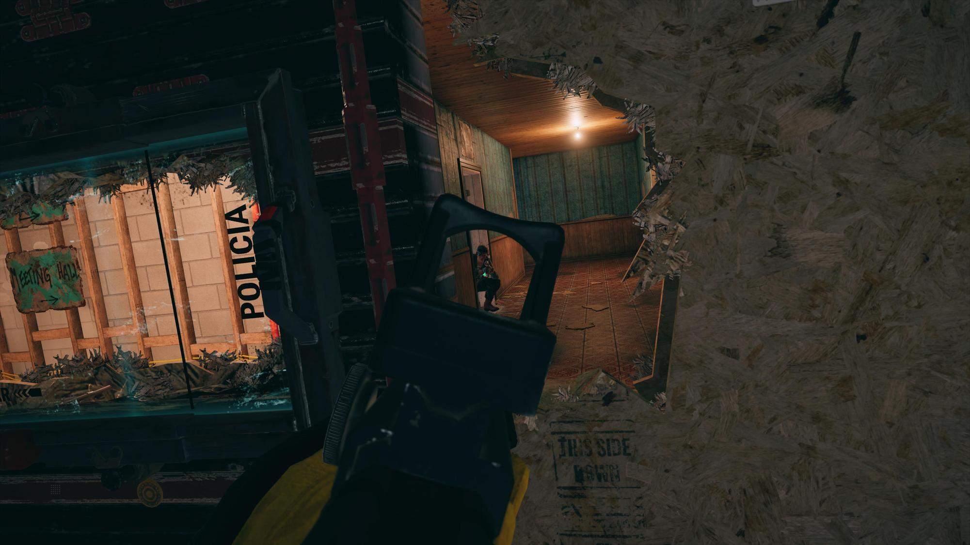 Widok z pierwszej osoby przez dziurę w ścianie. Broń na pierwszym planie. Korytarz w tle.