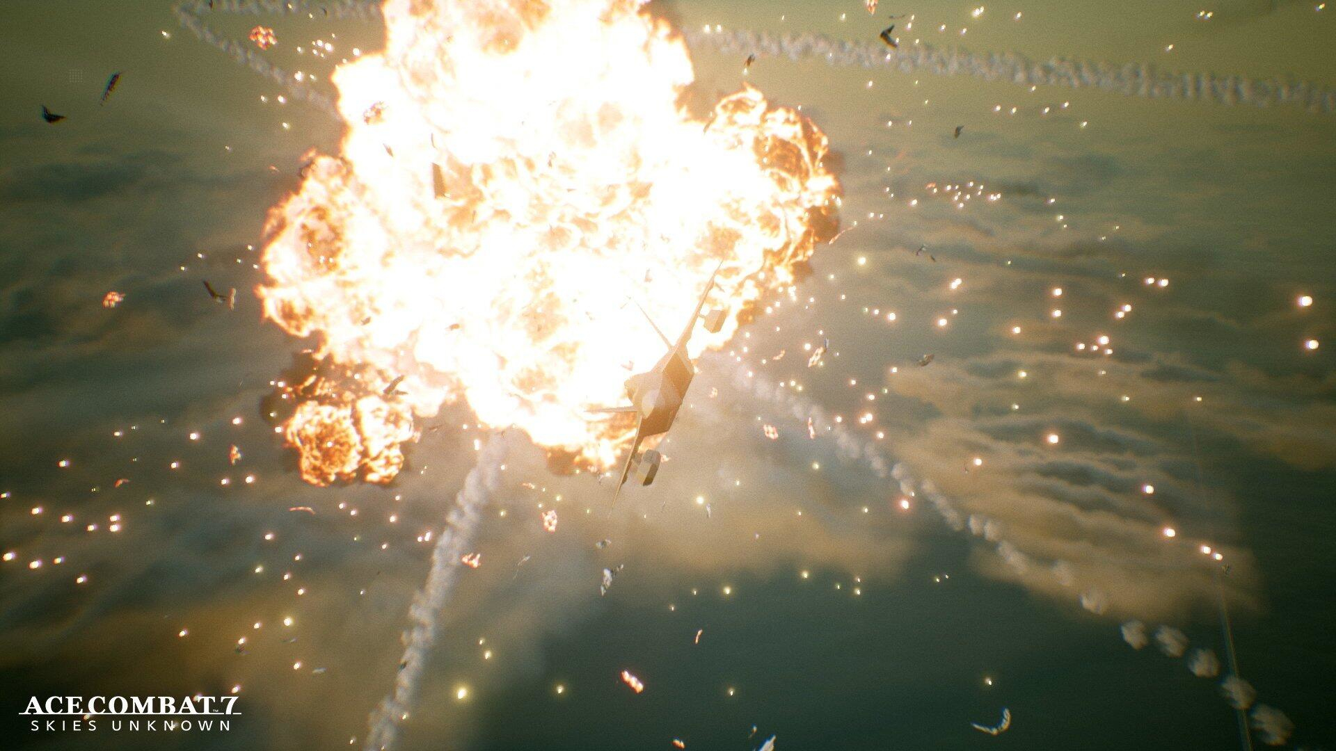 Samolot eksploduje na niebie z dużą kulą ognia i odłamkami. Dominują jasne kolory pomarańczowy i żółty.