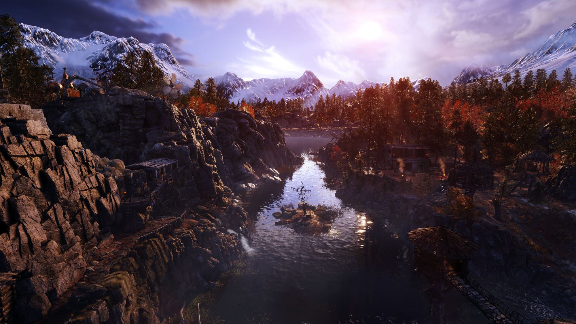 Widok krajobrazu jeziora otoczonego górami i drzewami. Niebo jest jasne, czyste niebieskie.