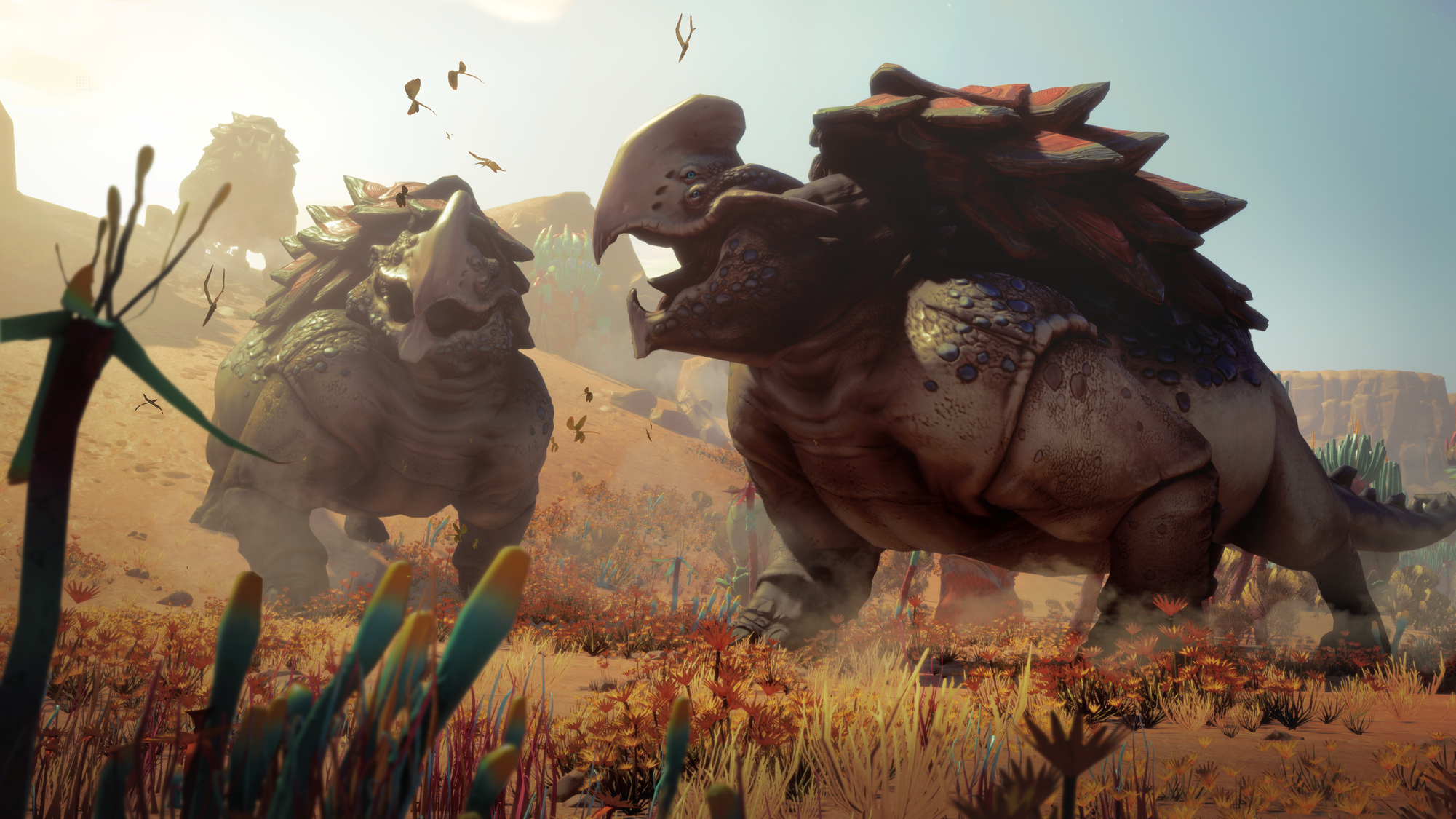 Dwa duże stworzenia podobne do dinozaurów w pustynnym krajobrazie z błękitnym niebem.