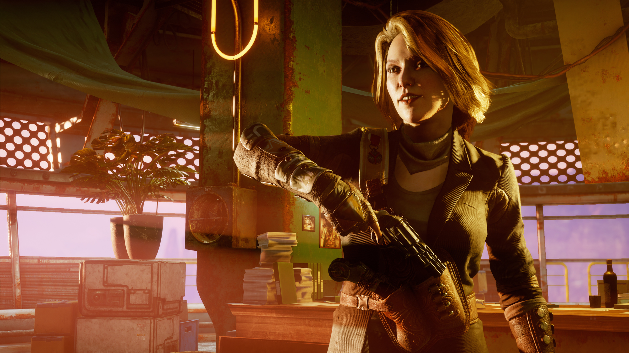 Kobieta trzymająca broń w pokoju. Wygląda surowo i ma na sobie kurtkę.