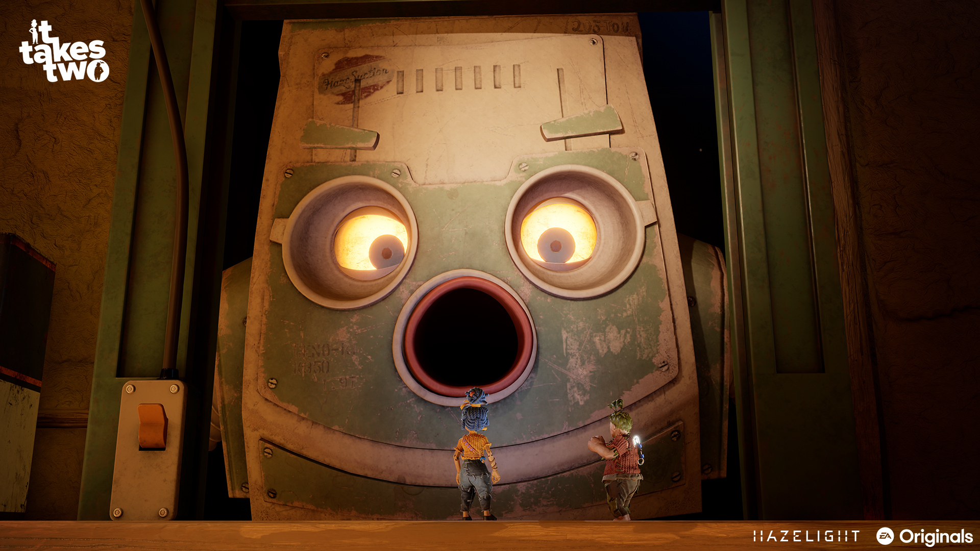 Dwie postacie stoją przed dużą głową robota. Tytuł gry 'It Takes Two' znajduje się w lewym górnym rogu.