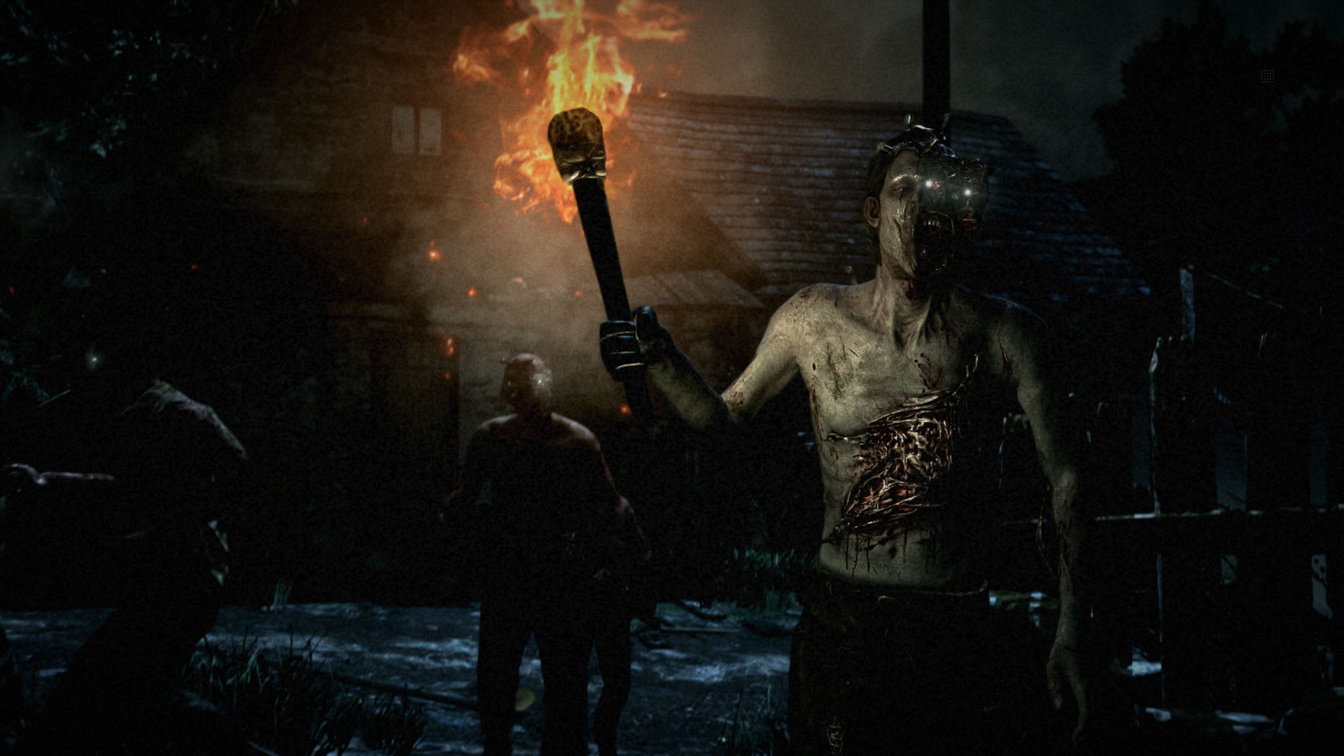 Zombi con fuoco e un uomo con una torcia in un'ambientazione oscura. Il gioco è un gioco horror.