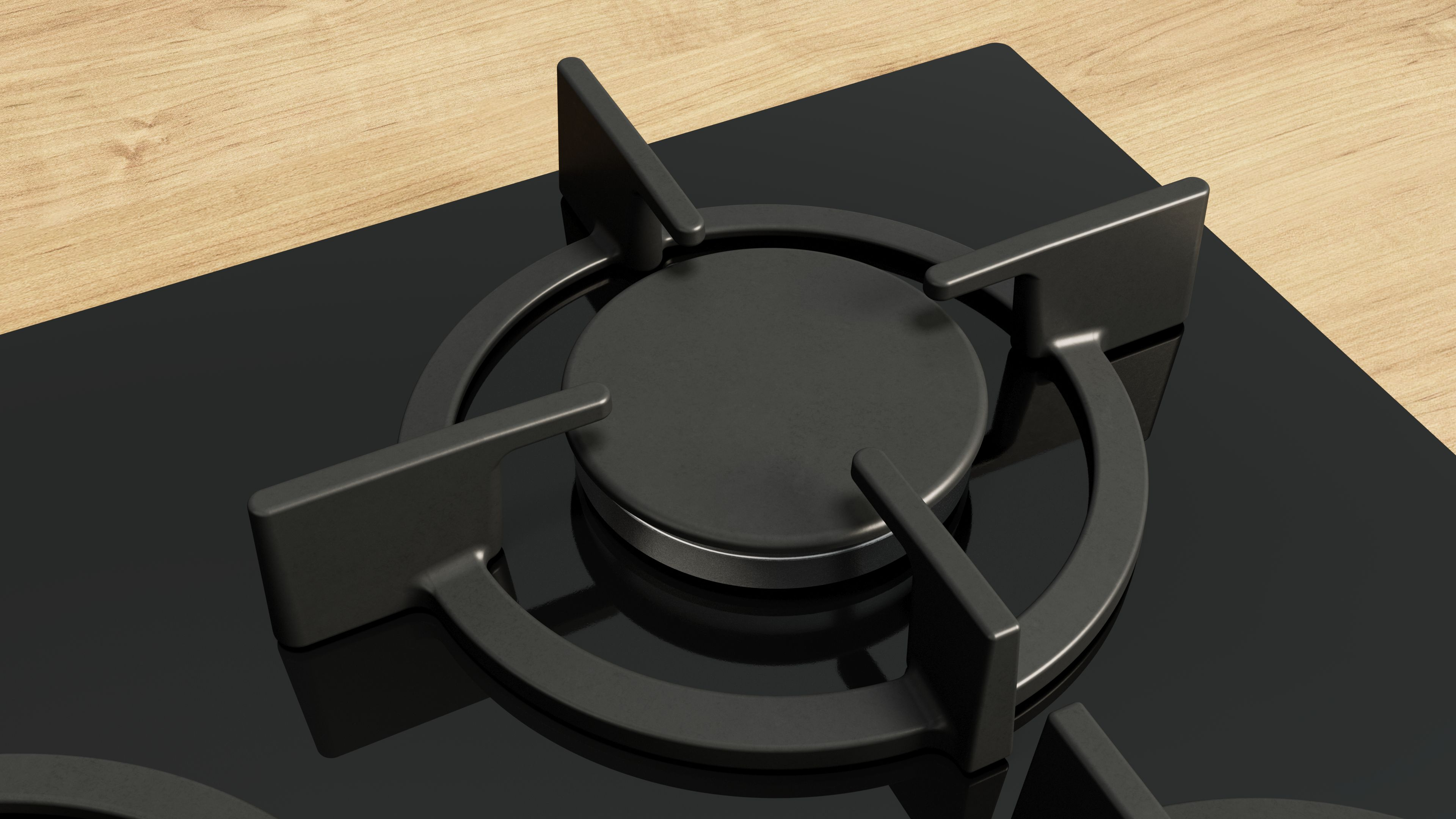 Czarna płyta gazowa z palnikiem w centrum. Ma cztery ramiona i centralny palnik.